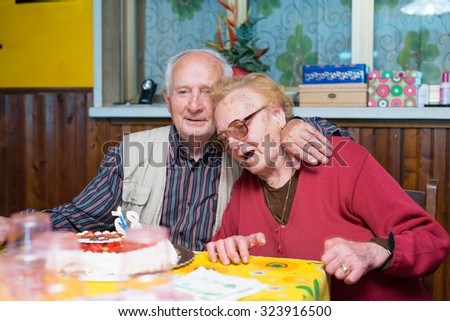 Family scene with senior retired couple indoor.
