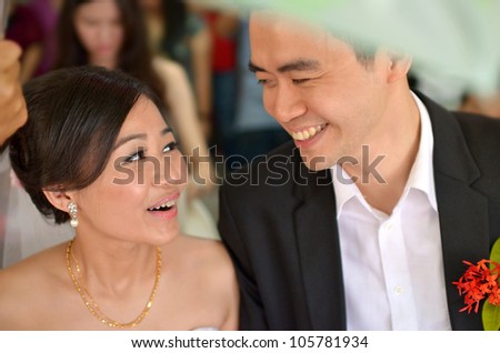 asian bride during their actual day wedding ,focus on bride\'s eyes