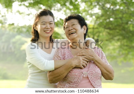asian mother and daughter smile