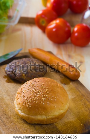 hamburger fast food ingredients with plenty of raw materials on the background