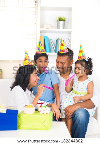 indian family birthday celebration with son and daughter