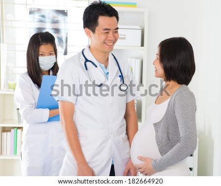 asian pregnancy check up with doctor and mother