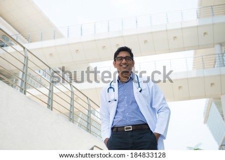 indian male doctor with hospital background