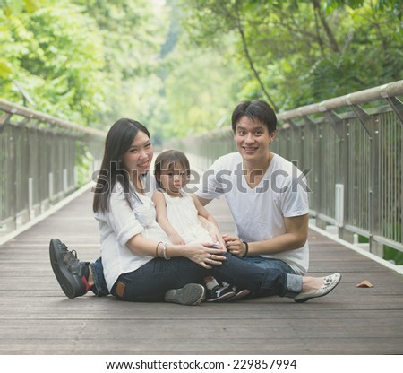 asian family enjoying outdoor park , vintage tone