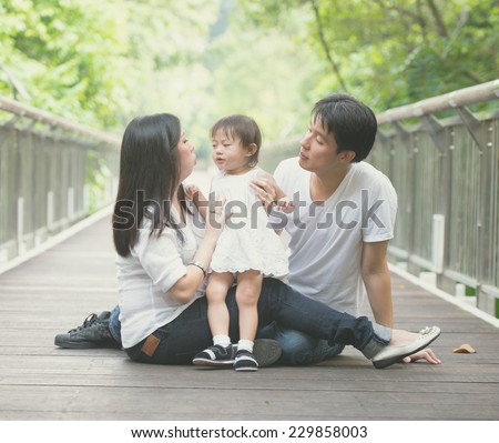 asian family enjoying outdoor park , vintage tone