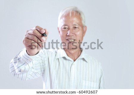 senior asian business man hodling a pen drawing