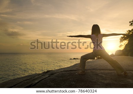 yoga girl performing yoga pose on a beach