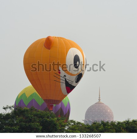 PUTRAJAYA, MALAYSIA - MARCH 29: Two hot air balloons fly on the air during 5th Putrajaya International Hot Air Balloon Fiesta on March 29, 2013 at Presint 2, Putrajaya.