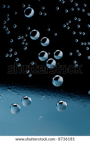 Air bubbles inside liquid on black background