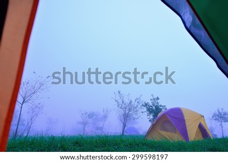 Camping Tent on hill under raining and mist