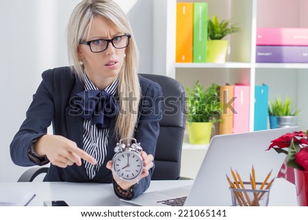 Frustrated business woman is angry about being late at work