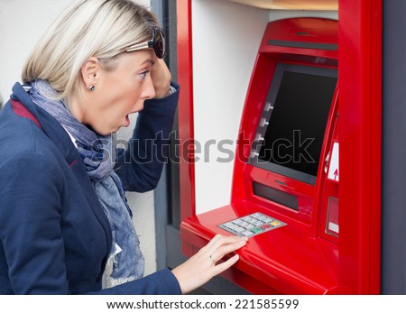 Shocked woman looking at her bank account balance