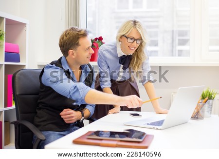 Young man and female colleagues working together in the office