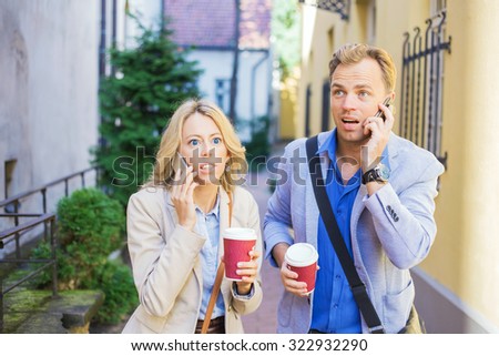 Surprised man and woman talking on the phone