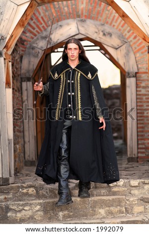 Young medieval blade-smith sword-cutler prince with black mantle like highlander