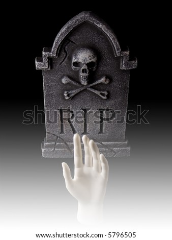 Tombstone with hand coming out of grave with fog