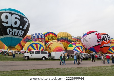 Albuquerque, NM, October 8: Rows of hot air balloons begin to inflate and stand up as people walk around and enjoy the Balloon Fiesta in Albuquerque, New Mexico on October 8th, 2014.