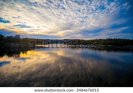 Similar – Image, Stock Photo Scenic sunset over peaceful sea and hilly shores