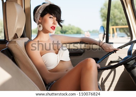 Beautiful young woman relaxing in car near the beach - outdoors