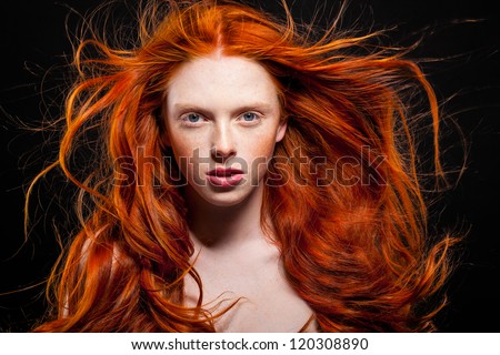 Golden Fashion Girl Portrait.Wavy Red Hair. Black Background