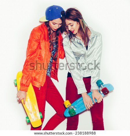 Two young sporty girl friends standing  together.  Emotion.  Hairstyle. Makeup.  White background, not isolated