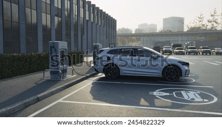 Similar – Foto Bild Elektrofahrzeug-Ladestation Schild Auto auf der Straße