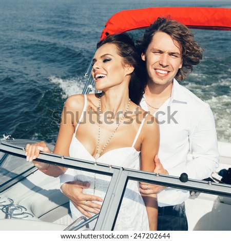 Young couple loving each other. Happy smiling man and woman on a sea voyage on a yacht.
