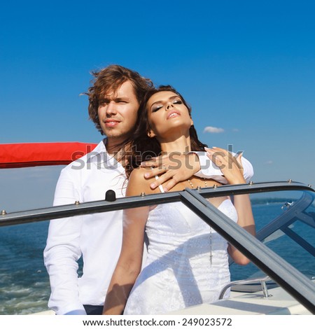 Young couple loving each other. Man and woman on a sea voyage on a yacht.