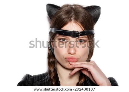 Young boring woman with leather cat ears. White background not isolated. Indoor lifestyle portrait of girl