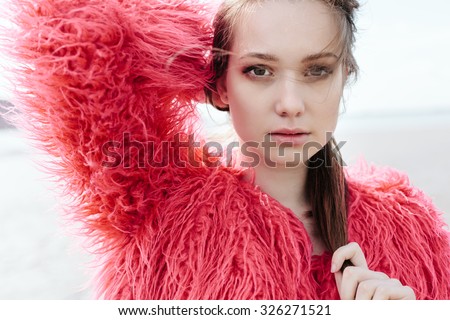 . Outdoors lifestyle portrait of the beautiful young woman close-up, the wind fluttering hair