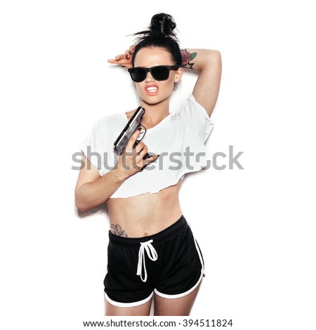 Stylish fashion swag girl with gun. White background, not isolated 394511824
