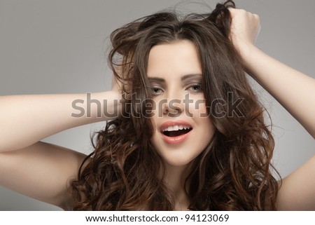 Very beautiful woman hands in her hair pulling.