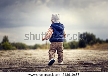 Little boy walking, picture from behind