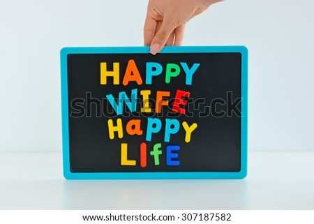 Happy wife happy life with magnetic colored letter blocks on blackboard
