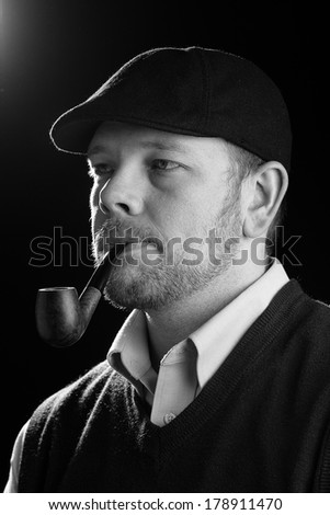 Man Holding Cigar - This is a high contrast black and white image of a young man holding a cigar. Shot on an isolated white background processed slightly to enhance detail.