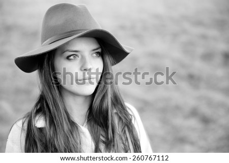 Serious Young Woman - This is a black and white portrait of a beautiful young woman looking off in the distance.