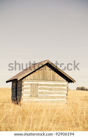 Cabin - This is a shot of an old log cabin sitting in the middle of a prairie. Shot with a warm retro color tone.