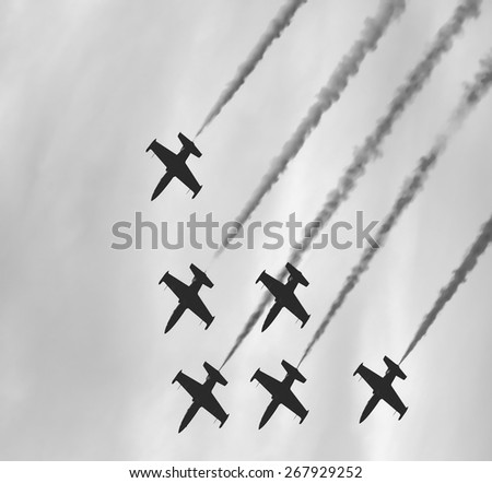 planes flying down synchronously.black and white