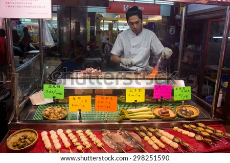 Kaohsiung, Taiwan - April 20,2015 : Chef cooking food to be sold in Liuhe Night Market in Kaohsiung, Taiwan
