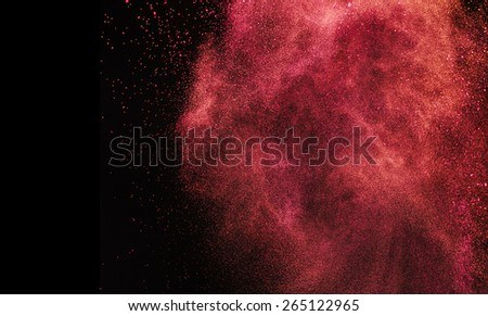 Splash of red paint on black background