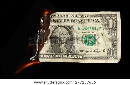 Burning dollar on black background