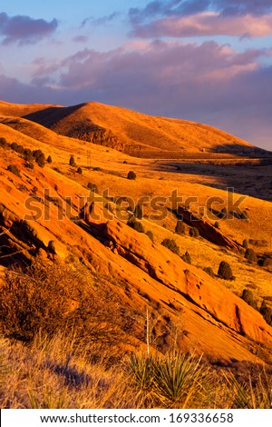 The sunrise casts it's warm colors on the landscape of Colorado at Red Rocks Park