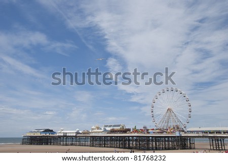 Central Pier Blackpool showing the Fairground Wheel under a summer sky