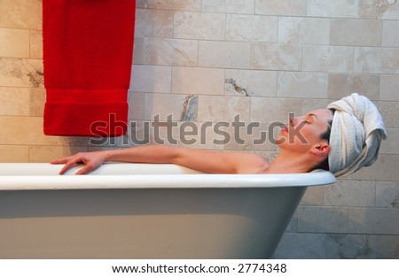 Woman in old fashion clawfoot tub.