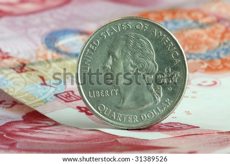 US coin stands on Chinese paper currency. Concept of economic relationship.