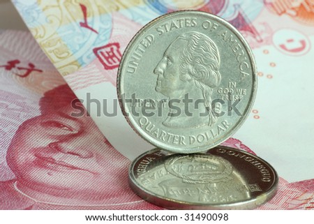 US coin stands on Chinese coin and paper currency