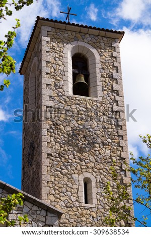 In the picture we can see the belfry with a blue sky with clouds