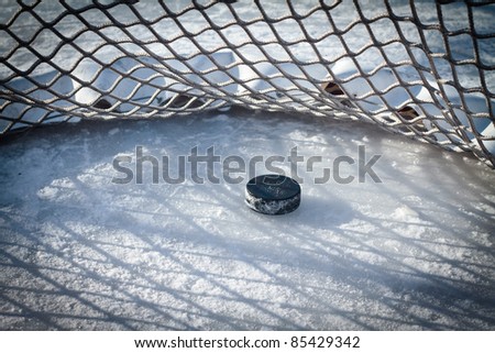 Hockey net with puck in goal