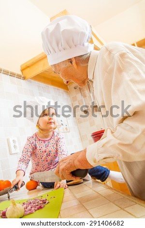 Little girl wanting to help grandmother in the kitchen.