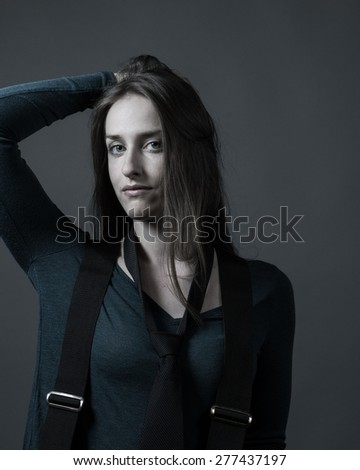 Female wears tie and suspenders over blouse